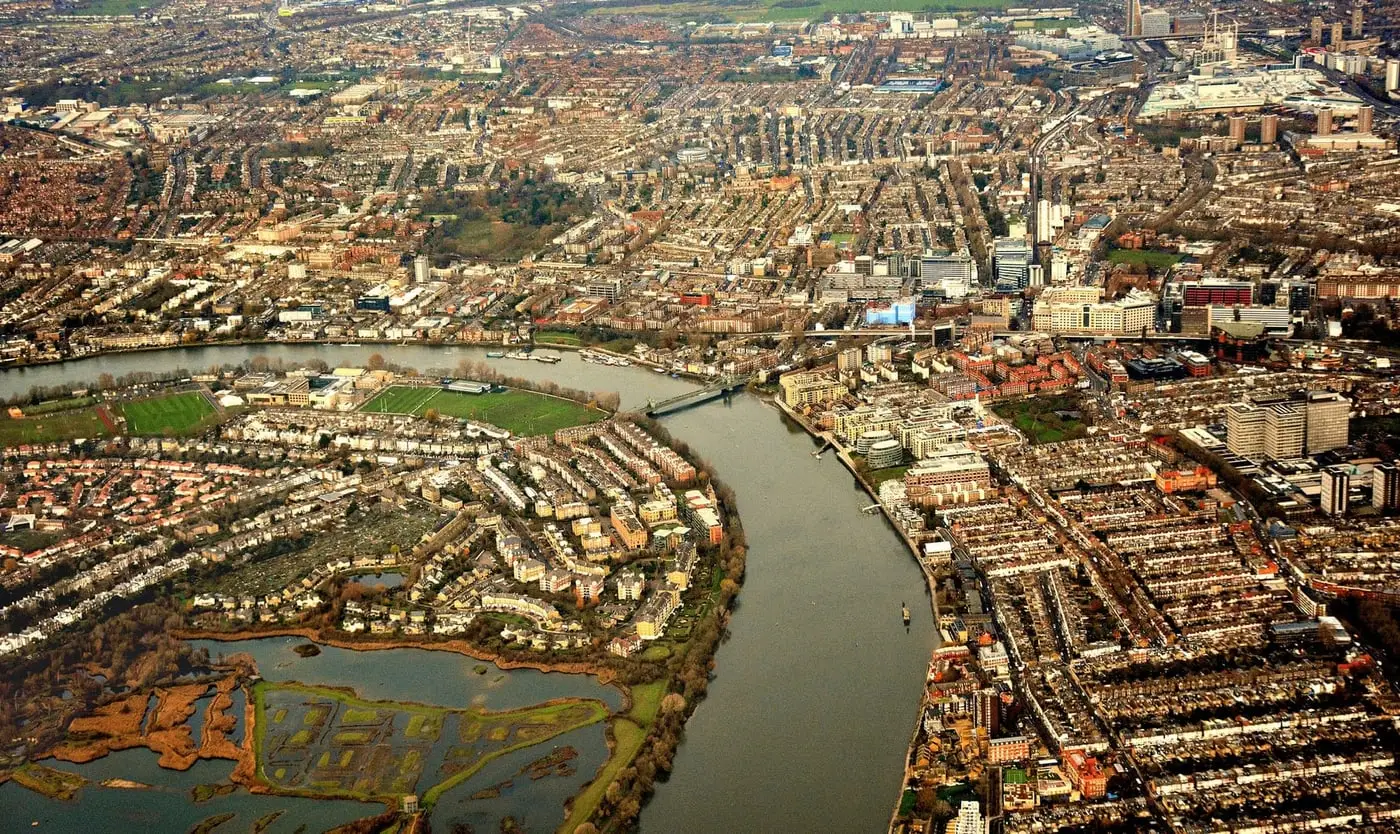 The Thames between Barnes and Hammersmith — reservoir wetland on one bank, dense riverside development on the other